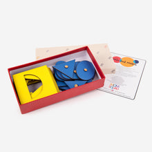 Load image into Gallery viewer, Puzzle of shapes, yellow stencils and blue insets in a mom squad box
